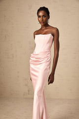 Woman wearing pink offshoulder floor length maxi dress with flowy design