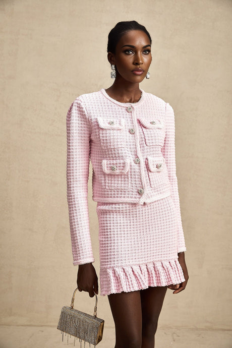 Woman wearing pink waffle knit jacket and matching skirt set called Fabienne