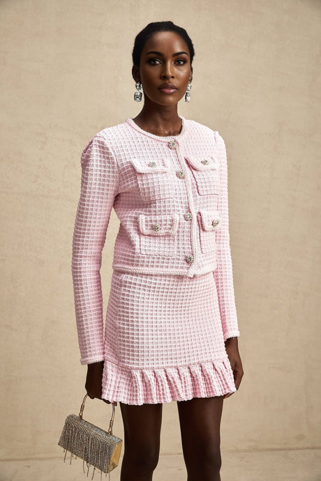 Woman wearing pink waffle knit jacket and matching skirt set named Fabienne