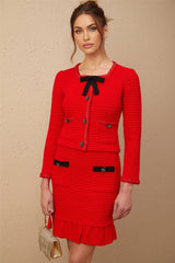 Woman wearing red braided waffle knit jacket and matching skirt set named Cynthia outfit has textured fabric and coordinated design