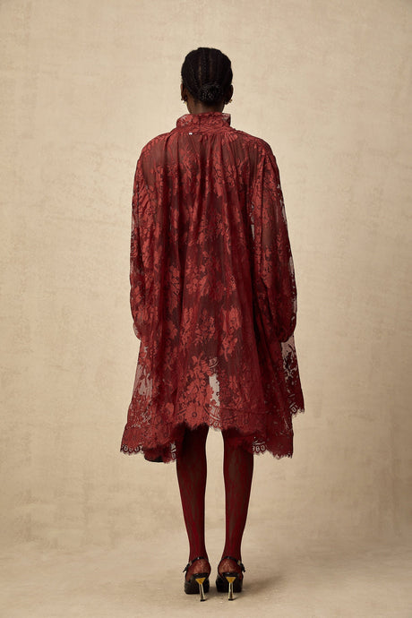 Woman wearing red floral lace tights with cutout pattern on legs