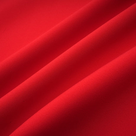 Woman wearing red mini dress with petal sleeves and bow detail featuring cutout design