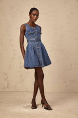 Woman wearing short blue denim dress with belt and long sleeves