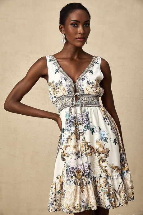 Woman wearing short floral print dress with vneck and short sleeves against plain background