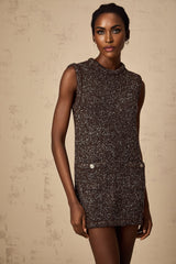 Woman wearing short knit dress in barley brown color with sequin embellishments