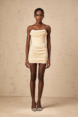 Woman wearing short neutral colored tulle dress with sequin embellishments