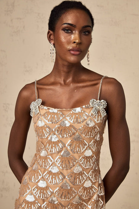 Woman wearing short sparkly dress with sequin embellishments