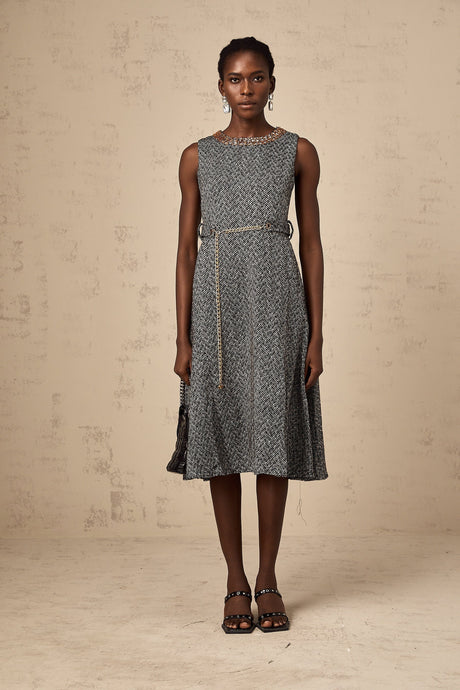 Woman wearing sleeveless grey tweed midi dress with crystal embellishments for Valentines Day occasion