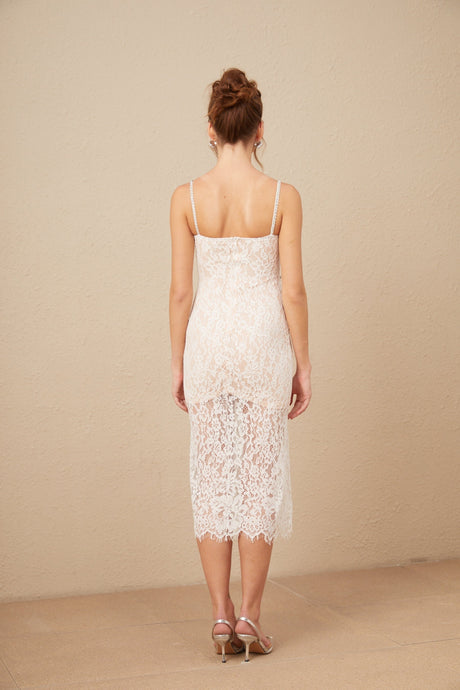 Woman wearing white lace midi dress with crystal embellished bustier top and fitted silhouette