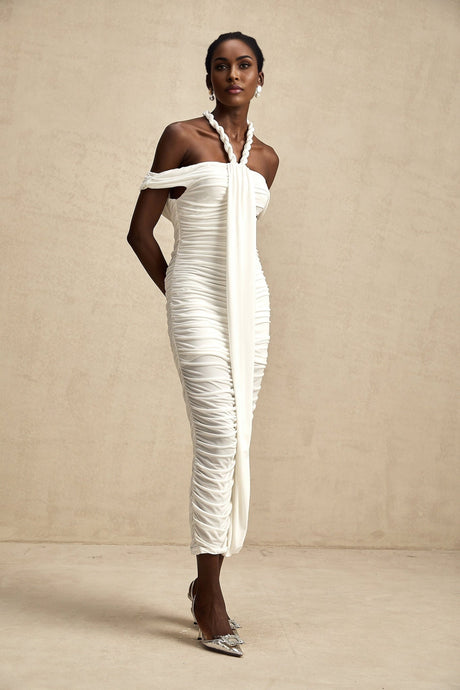 Woman wearing white midi dress with braided rope details and sleeveless design