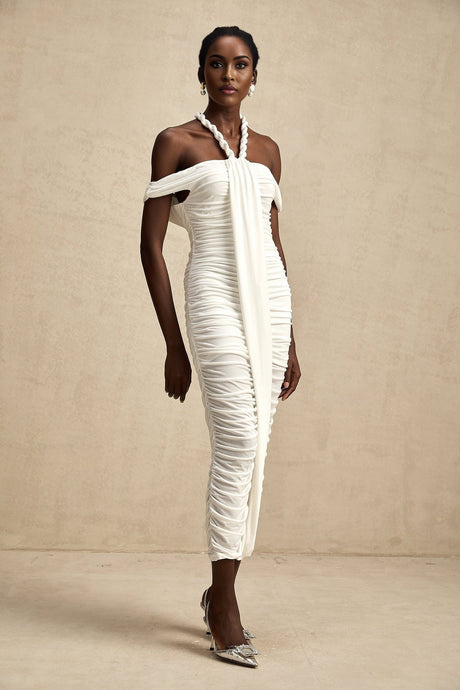Woman wearing white midi dress with braided rope details and sleeveless design