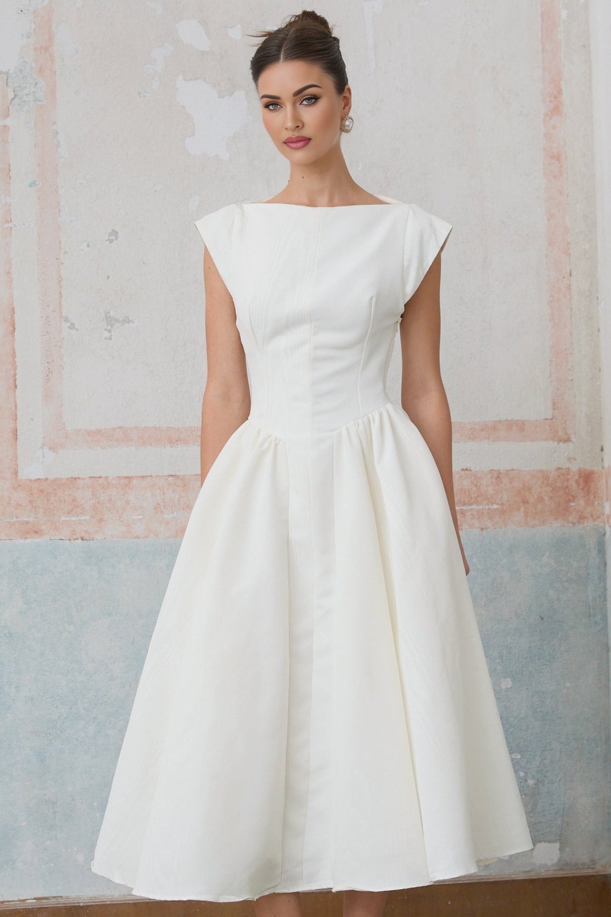 Woman wearing white midi dress with cap sleeves and open back design