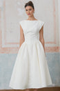 Woman wearing white midi dress with cap sleeves and open back design
