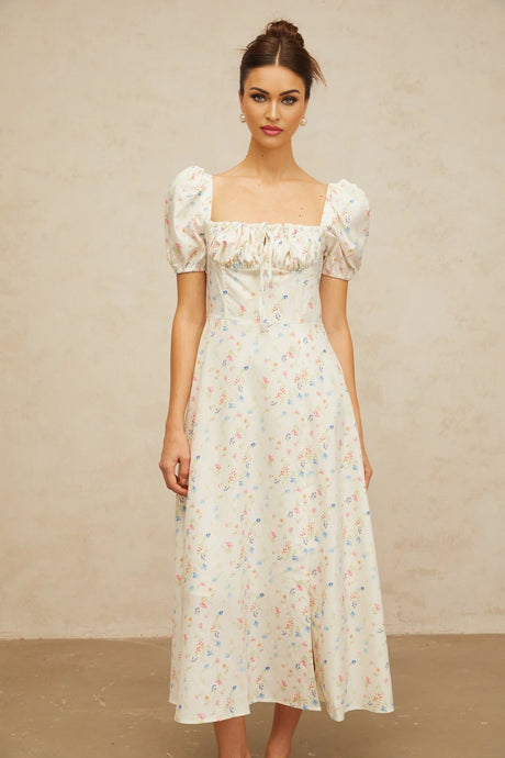 Woman wearing white midi dress with floral print and flared skirt