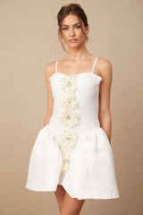 Woman wearing white mini dress with floral pattern and bustier top