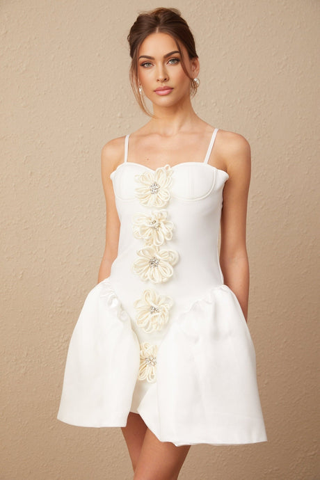 Woman wearing white mini dress with floral pattern and bustier top