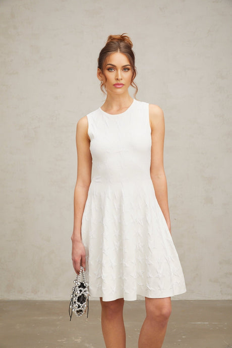 Woman wearing white mini dress with star pattern knit fabric and short sleeves