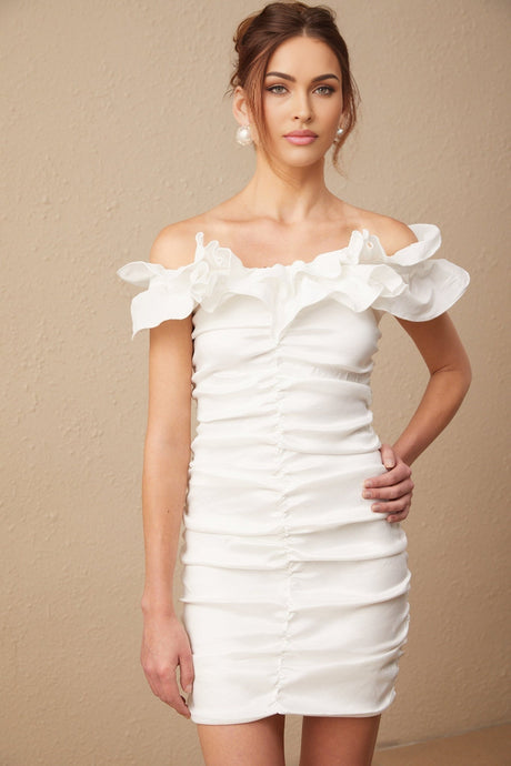 Woman wearing white off shoulder mini dress with ruffled details