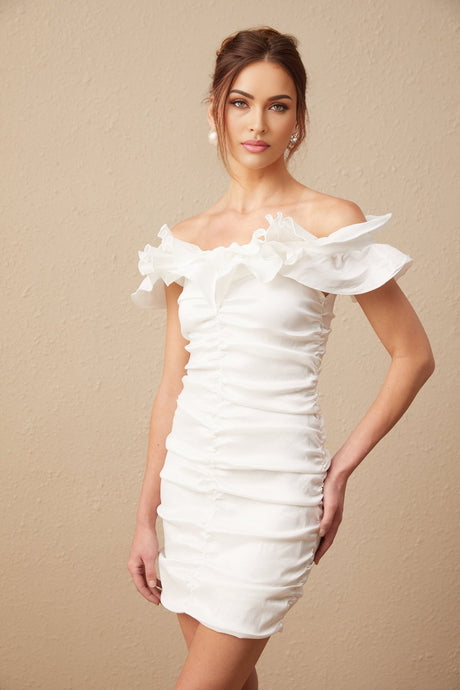 Woman wearing white off shoulder mini dress with ruffled details