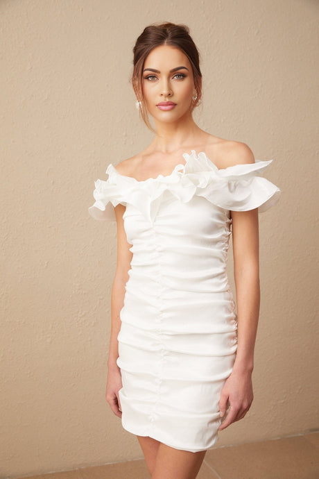 Woman wearing white off shoulder mini dress with ruffled details
