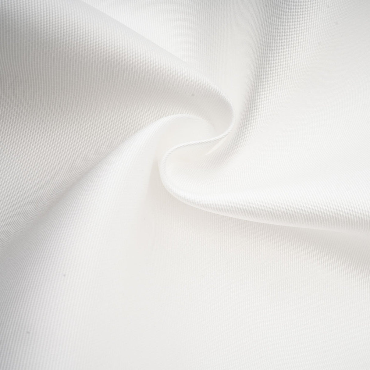 Woman wearing white offshoulder maxi dress with panelled design standing against plain background