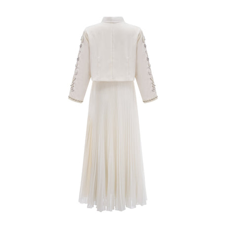 Woman wearing white pleated jacket and dress set with embellishments Blanche collection Matching outfit for formal occasions