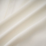 Woman wearing white pleated jacket and dress set with embellishments Blanche design