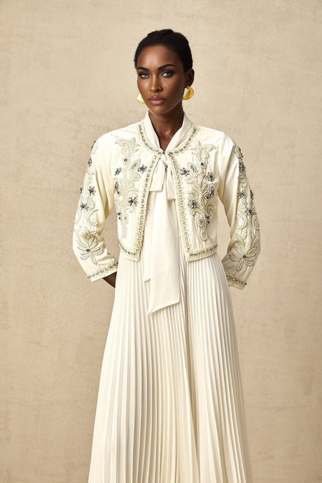 Woman wearing white pleated jacket and dress set with embellishments Blanche matching outfit formal wear