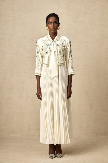Woman wearing white pleated jacket and dress set with embellishments Blanche style matching outfit