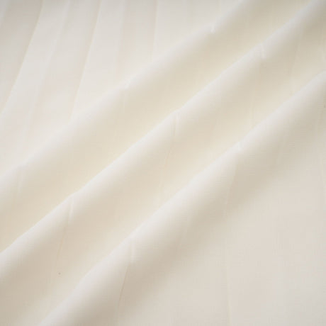 Woman wearing white pleated jacket and matching dress with embellishments Blanche set