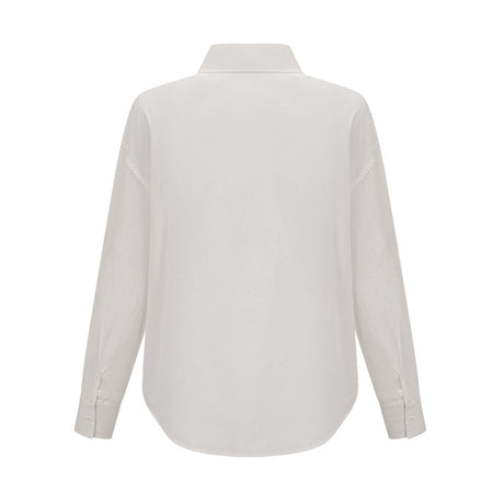 Woman wearing white shirt with floral pattern and cutout details