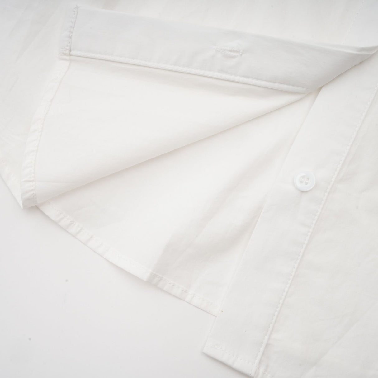 Woman wearing white shirt with floral pattern and cutout details