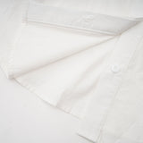 Woman wearing white shirt with floral pattern and cutout details