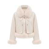 Woman wearing white suede short coat with fur trim and padded design