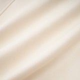 Woman wearing white suede short coat with fur trim and padded design