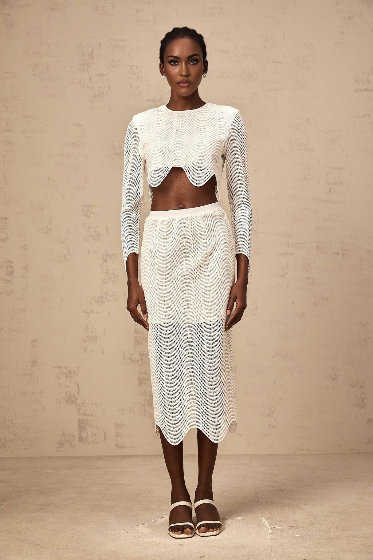 Woman wearing white wavy woven top and matching skirt set called Constance