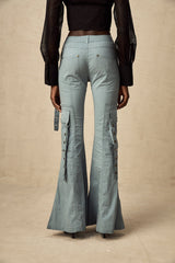Woman wearing wide leg cargo pants with flared silhouette and belt loops in neutral color