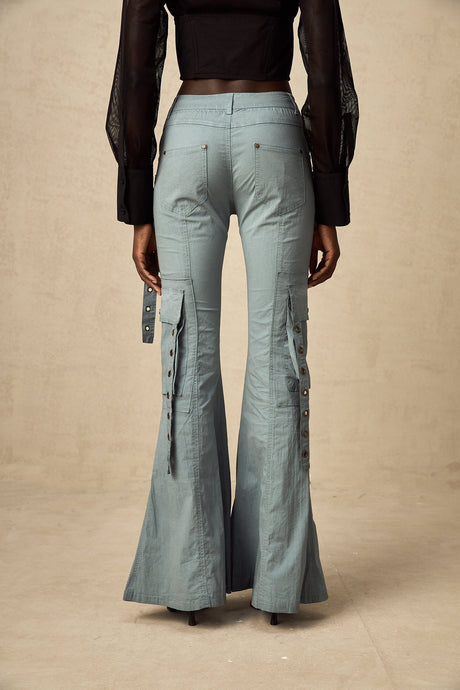 Woman wearing wide leg cargo pants with flared silhouette and belt loops in neutral color