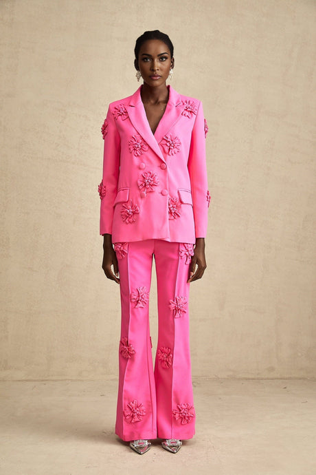 Young girl wearing a pink floral jacket with matching trousers set named AmelieRose
