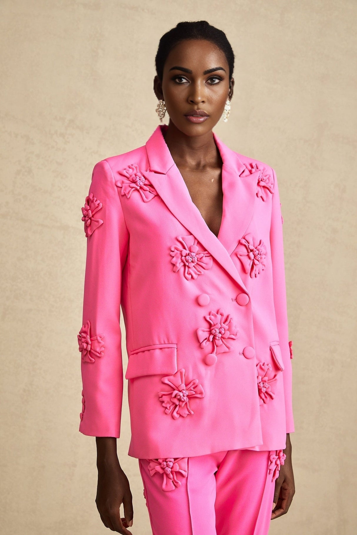 Young girl wearing pink floral jacket and matching trousers set called AmelieRose