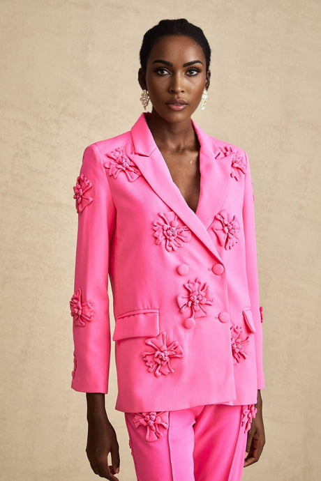 Young girl wearing pink floral jacket and matching trousers set called AmelieRose