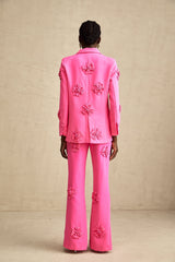 Young girl wearing pink floral jacket and matching trousers set named AmelieRose