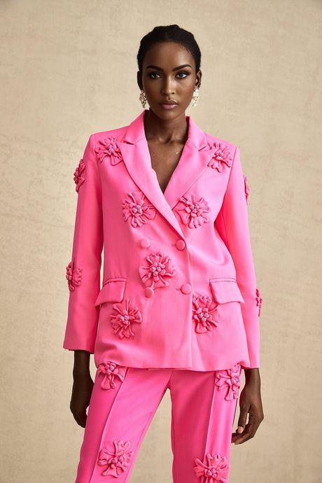 Young girl wearing pink floral jacket and matching trousers set named AmelieRose