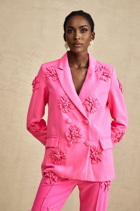 Young girl wearing pink floral jacket and matching trousers set named AmelieRose
