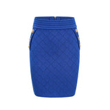 Young woman wearing a blue knitted two piece outfit consisting of a long sleeve top with button details and a matching skirt