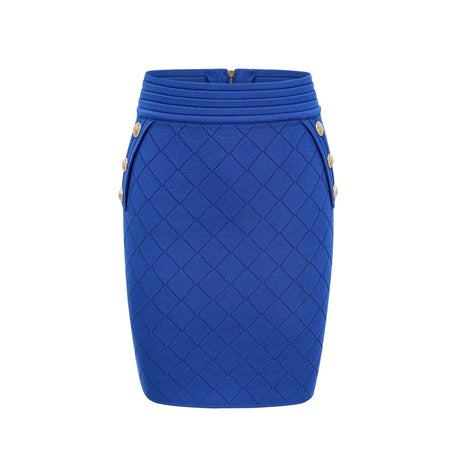 Young woman wearing a blue knitted two piece outfit consisting of a long sleeve top with button details and a matching skirt