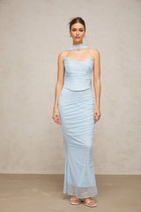 Young woman wearing a blue matching set consisting of a ruched tulle top and skirt with gathered fabric details