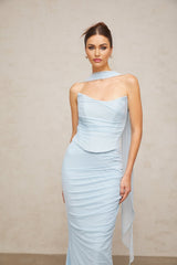 Young woman wearing a blue matching set consisting of a ruched tulle top and skirt with gathered fabric details