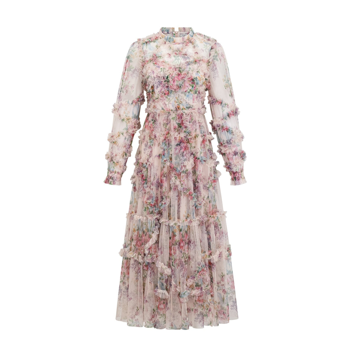Young woman wearing a floral patterned midi dress with ruffled tulle details and a fitted bodice standing in a garden setting