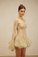 Young woman wearing a green mini dress with floral embroidery and flared skirt